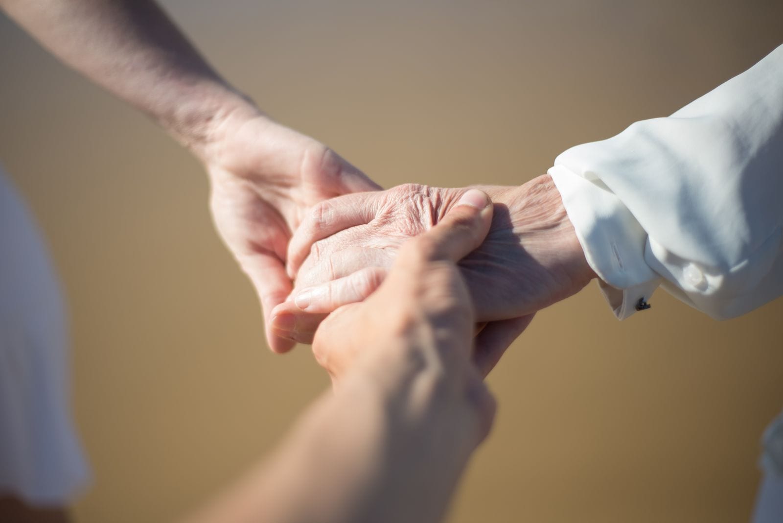 Hands held together in support